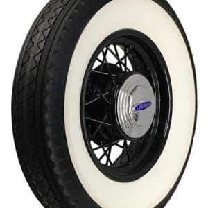 A classic car tire, size 750-18 Bedford 4-1/4" DWW, with a white sidewall and black tread, mounted on a spoked black wheel with a Lincoln
